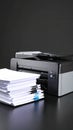 Office Printer and Stack of Paper Documents on Dark Surface Royalty Free Stock Photo