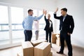 Office Relocation. Executives Making High Five Royalty Free Stock Photo