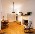 Office with rocking chair and parquet in the renovated apartment