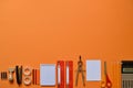 Office or school supplies on orange paperboard Royalty Free Stock Photo
