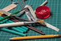 Office, school supplies. Scissors, brushes, paper clips, pencils on a cutting mat Royalty Free Stock Photo