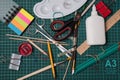 Office, school supplies. Scissors, brushes, paper clips, pencils on a cutting mat Royalty Free Stock Photo