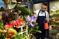 office service worker with fresh flowers and potted plants Royalty Free Stock Photo