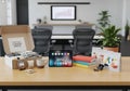 Office setting featuring a wooden table with various items. A tablet Royalty Free Stock Photo