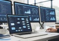Office setting with multiple monitors displaying data analytics and Royalty Free Stock Photo