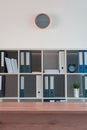 Office shelf with document binders and stationery