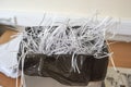 office shredder with overflowing cut paper