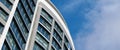 Office skyscraper high business building on blue sky background, looking up to glass modern building Royalty Free Stock Photo