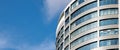 Office skyscraper high business building on blue sky background, looking up to glass modern building Royalty Free Stock Photo