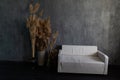 Office sofa and dried flowers in room interior with dark grey wall Royalty Free Stock Photo