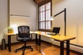 office space with ergonomic desk, chair, and lighting