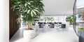 Office space with large panoramic windows and many plants around and inside