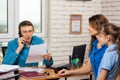 Office specialist calls on the phone, at the reception mother with the child