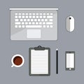 Office stuff with laptop, cup of cofee, and smartphone. Top view with copy space. Office supplies and gadgets on desk table. Royalty Free Stock Photo