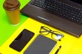 Office stuff with pen, paper notebook,smartphone,laptop eyeglasses coffe cup.Top view.Working colorful desk table Royalty Free Stock Photo