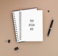 Office supplies in black color on a craft paper background with spiral notepads mockup Royalty Free Stock Photo