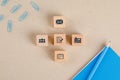 Office supplies concept with icons on wooden cubes, stationery set on paper background flat lay Royalty Free Stock Photo