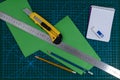 Office supplies on green cutting mat board Royalty Free Stock Photo