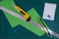 Office supplies on green cutting mat board Royalty Free Stock Photo