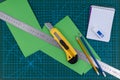 Office supplies on green cutting mat board Royalty Free Stock Photo