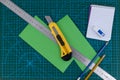 Office supplies on green cutting mat board Royalty Free Stock Photo