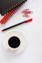 Office supplies with spiral notebook, pen, paperclips, and cup o Royalty Free Stock Photo