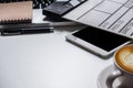 Office supplies are tablet, pen, computer, notebook, mobile phone and red coffee mug placed at an office desk. Royalty Free Stock Photo