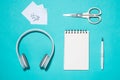 Office supplies. Top view on opened notebook, pen and headphone Royalty Free Stock Photo