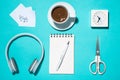 Office supplies. Top view on opened notebook, pen, headphone, cl Royalty Free Stock Photo
