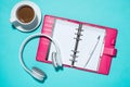 Office supplies. Top view on opened notebook, pen, headphone and Royalty Free Stock Photo