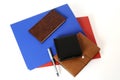Blue, brown, red, black, colored stationery scattered on the table