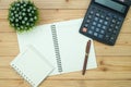 Office supplies or office work essential tools items on wooden desk in workplace, pen with notebook and calculator, top view Royalty Free Stock Photo