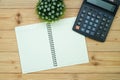 Office supplies or office work essential tools items on wooden desk in workplace, pen with notebook and calculator, top view Royalty Free Stock Photo