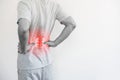 Office syndrome, Backache and Lower Back Pain Concept. a man touching his lower back at pain point Royalty Free Stock Photo