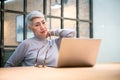 Mature asian business woman wears glasses using laptop computer sit at workplace desk Royalty Free Stock Photo