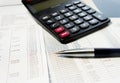 Office table with calculator, pen and accounting document Royalty Free Stock Photo