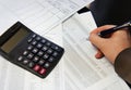 Office table with calculator, pen and accounting document Royalty Free Stock Photo