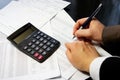 Office table with calculator, pen and accounting document