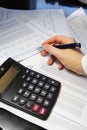 Office table with calculator, pen and accounting document Royalty Free Stock Photo