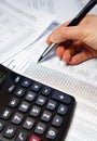 Office table with calculator, pen and accounting document Royalty Free Stock Photo