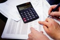 Office table with calculator, pen and accounting document Royalty Free Stock Photo