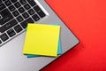 Office table desk with set of colorful supplies, white blank note pad, cup, pen, pc, crumpled paper, flower on red Royalty Free Stock Photo