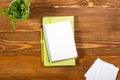 Office table desk with set of colorful supplies, white blank note pad, cup, pen, pc, crumpled paper, flower on wooden Royalty Free Stock Photo