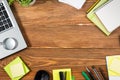 Office table desk with set of colorful supplies, white blank note pad, cup, pen, pc, crumpled paper, flower on wooden Royalty Free Stock Photo