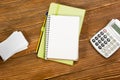 Office table desk with set of colorful supplies, white blank note pad, cup, pen, pc, crumpled paper, flower on wooden Royalty Free Stock Photo