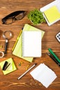 Office table desk with set of colorful supplies, white blank note pad, cup, pen, pc, crumpled paper, flower on wooden Royalty Free Stock Photo