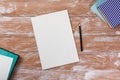 Office table desk with supplies, white blank note pad, cup, pen, pc, crumpled paper, flower on wooden background. Top Royalty Free Stock Photo