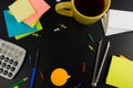 Office table desk top view with set of colorful supplies, white blank note pad, cup, pen, pc, crumpled paper, flower on Royalty Free Stock Photo