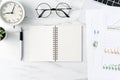 Office table desk work with blank notebook, report and alarm clock on marble white background Royalty Free Stock Photo