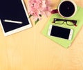 Office table with digital tablet, smartphone, reading glasses and cup of coffee. View from above Royalty Free Stock Photo